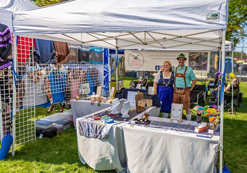 IMG_9602_CC_web Artisan and craft vendor tent at Oktoberfest showcasing handmade goods and local products.